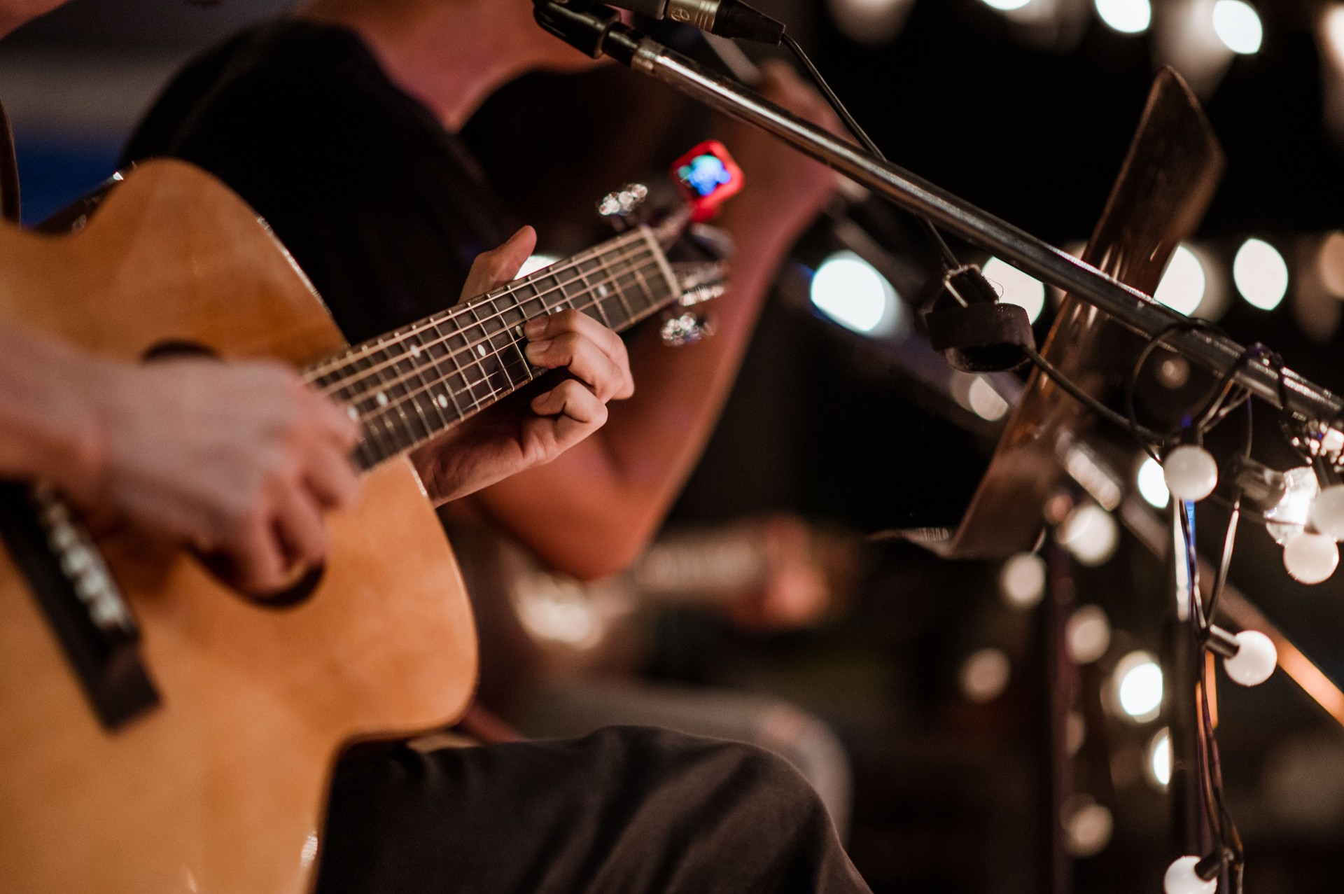 The musician plays and the lead singer sings on stage at the music festival at night.
Concert,mini concert and music festivals.